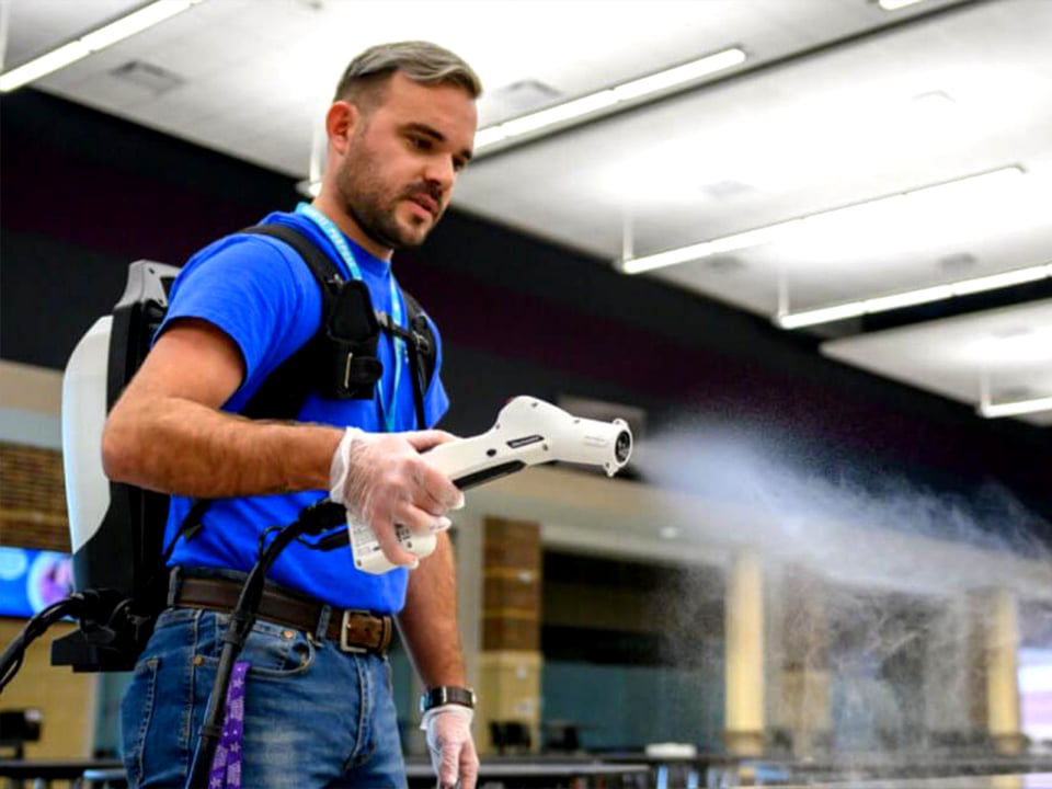 Man wearing gloves uses Electrostatic Backpack Sprayer