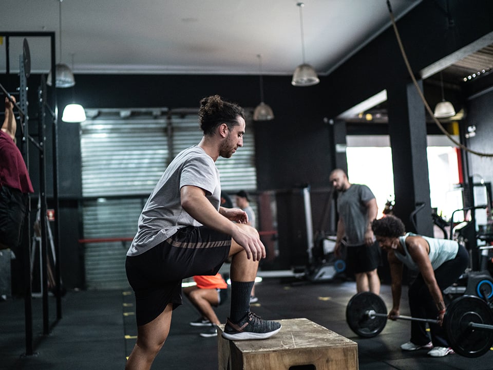 Man in gym clothes exercises on gym workout bench 