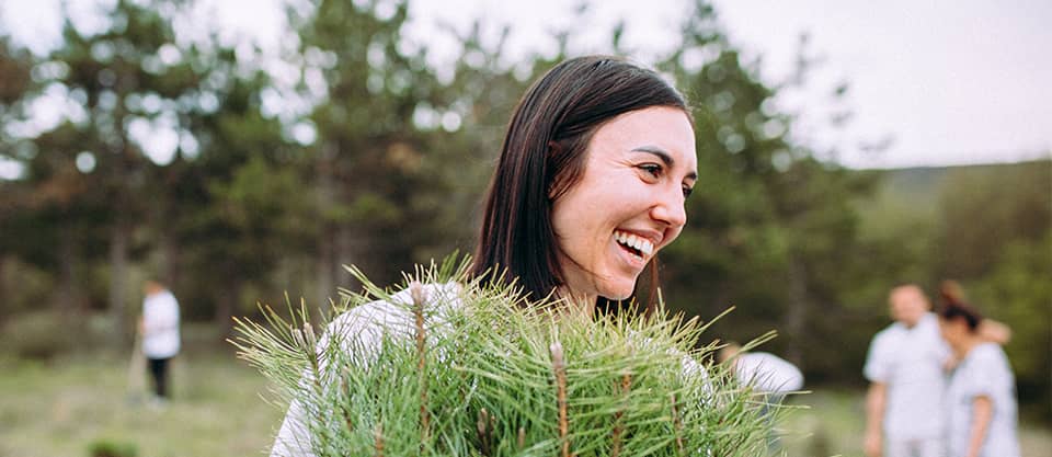 woman with plant smiling