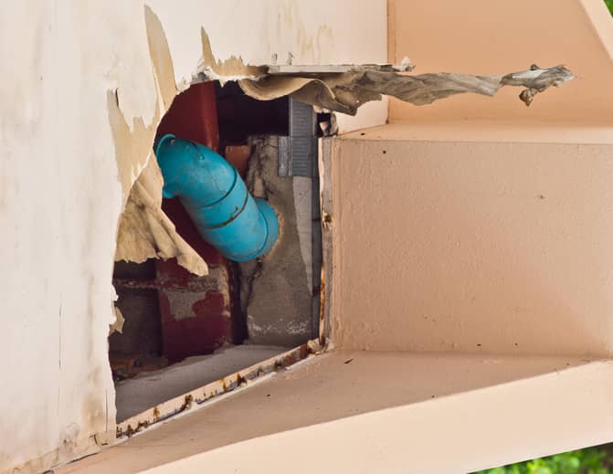 broken wall with exposed pipe
